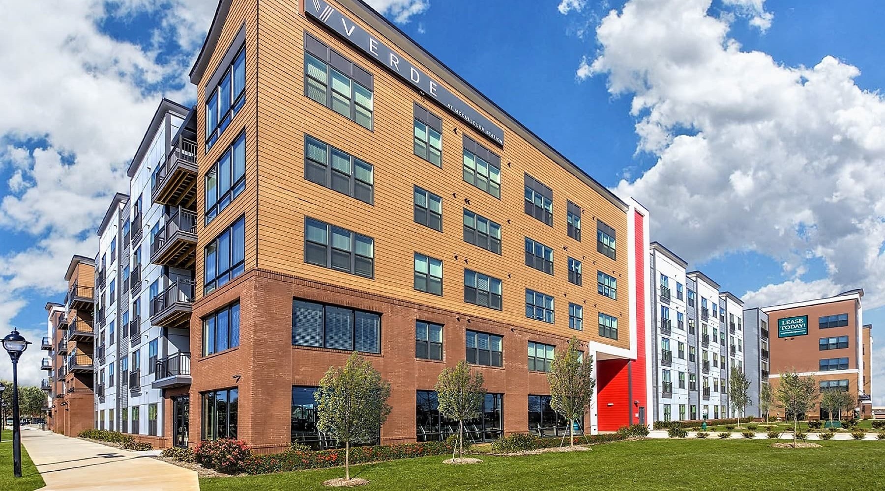 EXPLORE THE NEIGHBORHOOD street-view of property building showing near landscaping